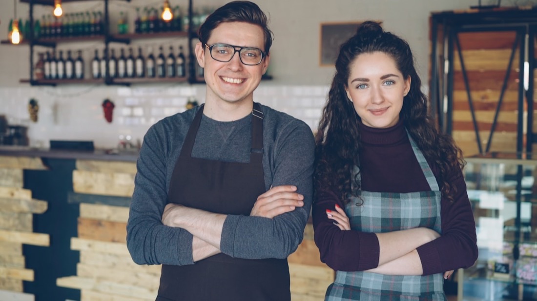 Happy local business owners in their shop